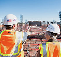 man in white hard hat standing on brown