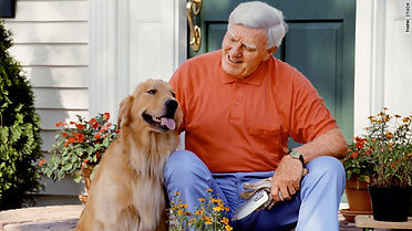 Man petting dog sitting on door steps