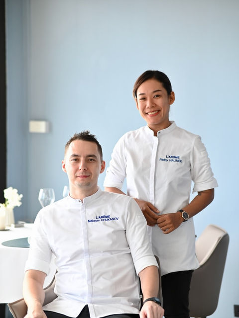 Executive Chef Maksym Chukonov and Chef de Cuisine Padoy standing together in the kitchen of L’Arôme by the Sea, dressed in chef uniforms, representing culinary leadership and teamwork.