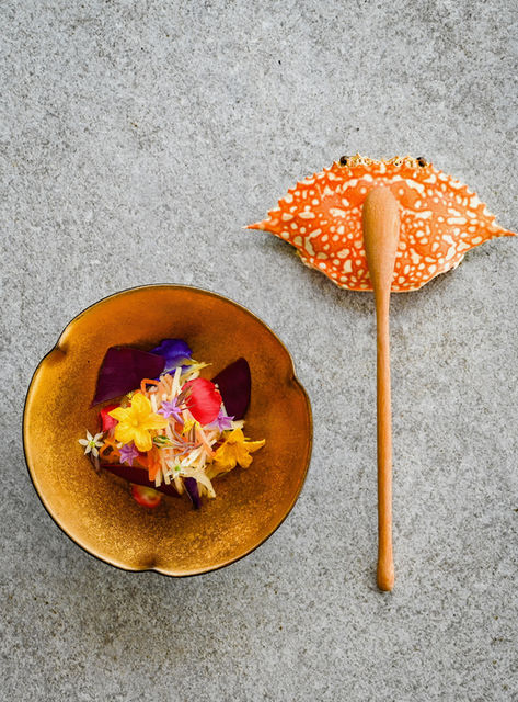 Elegant presentation of L’Arôme by the Sea’s Flower & Brown Crab Salad, featuring vibrant crab meat atop a fine dining salad with herbs and delicate plating.