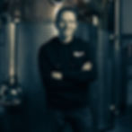 Chris Toller, Founder, Henstone Distillery in front of the still at his distillery