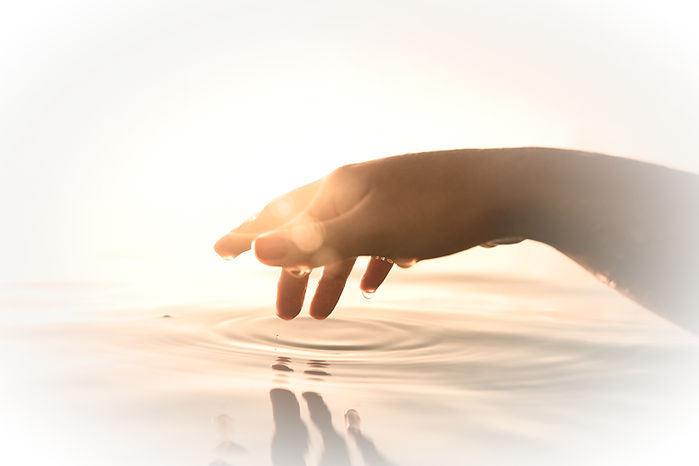Hand almost touching the surface of water with water droplets on each digit