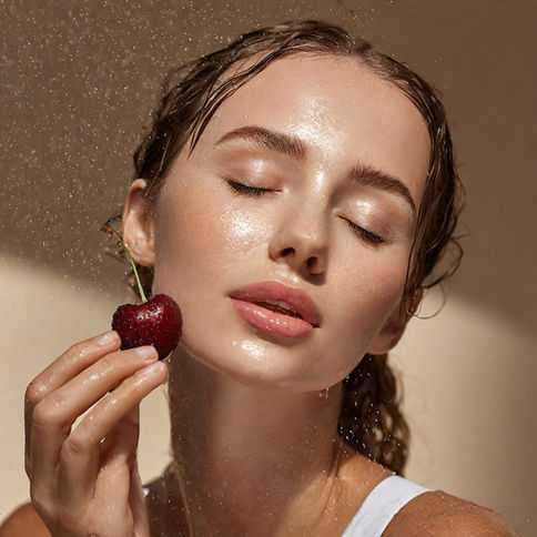 woman holding cherry
