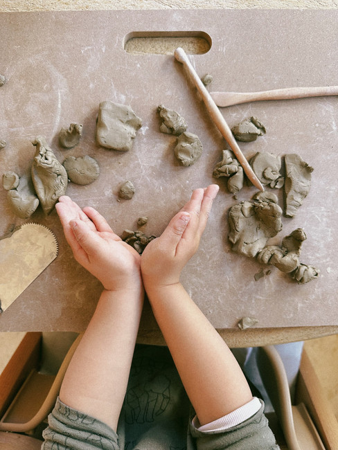 Toddler hands and pottery clay