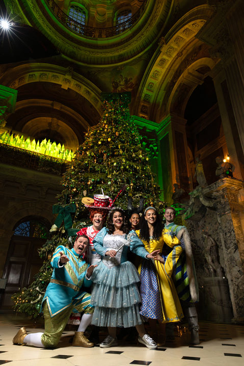 the cast of York Theatre Royal panto sleeping beauty pose in front of Castle Howard at night.