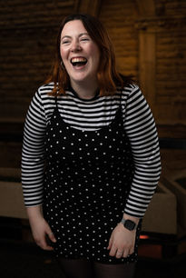 a laughing employee of York Theatre Royal against a dark background