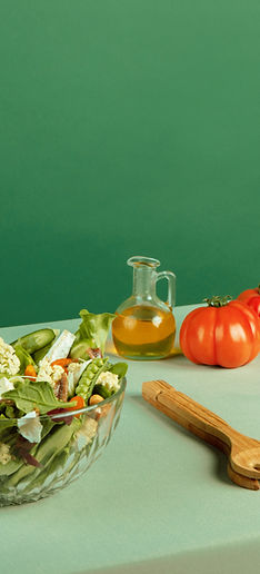 A vibrant flat lay of five gourmet meal prep entrees in modern black containers creamy Tus