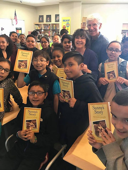 Ginger and Larry Katz with the Elementary School children who read her book as part of their class.