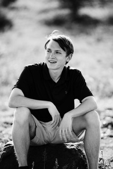 Safari Portrait of a young man sitting in the bush at Thornybush Game Reserve