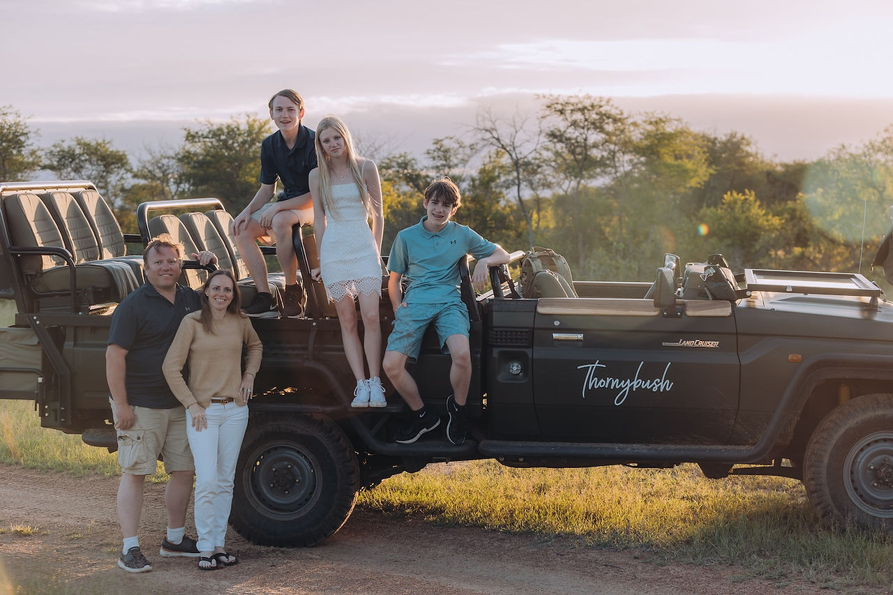 Safari Family Portrait with a game drive vehicle at Thornybush Game Reserve