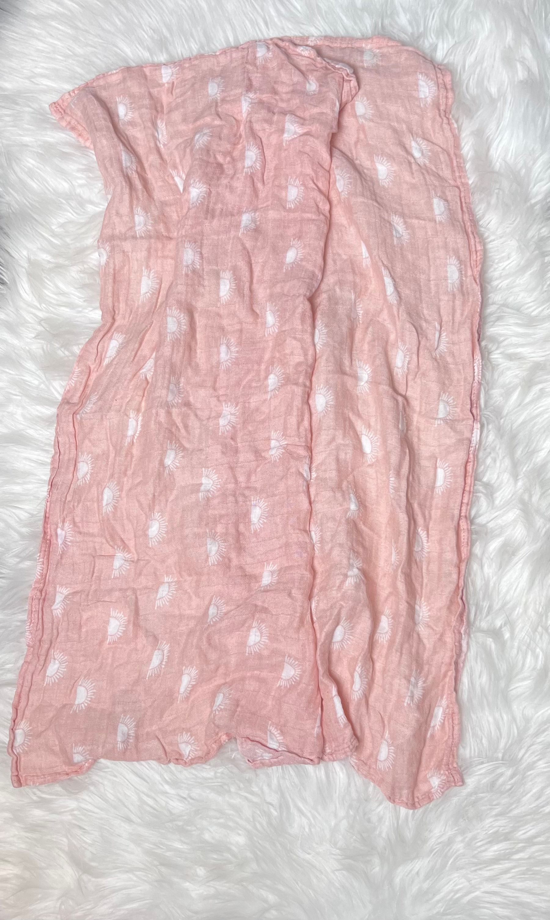 Gllquen Muslin Swaddle Blanket, light orange with white sun print.