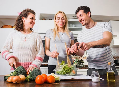 people preparing a healthy salad with fresh vegetables in lakeville mn after receiving nutrition counseling.
