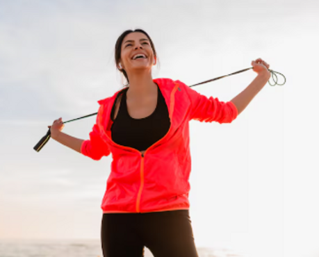 woman enjoying an outdoor jump rope workout feeling happy after visiting a wellness center in lakeville mn.