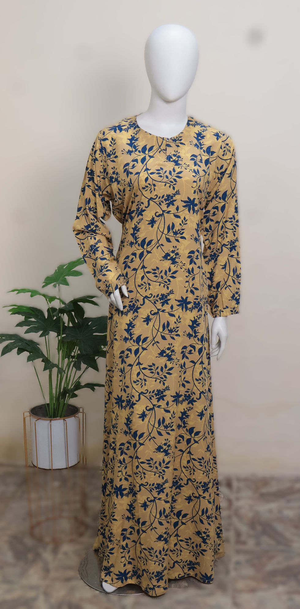 Thumbnail: The Serenity Edit Mustard Botanical Printed Abaya by Manalosha featuring a mustard yellow base with navy floral print, long s