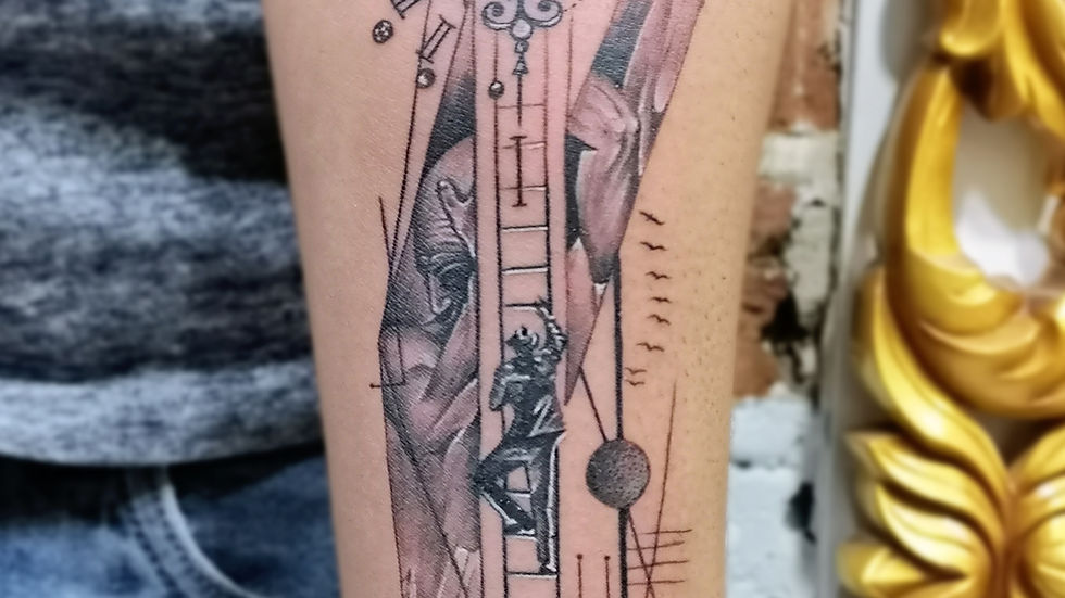 Close-up view of a forearm with a black abstract geometric tattoo featuring clean lines and sharp angles