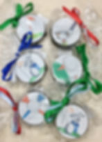 Six golf-themed decorated treats with colorful ribbons