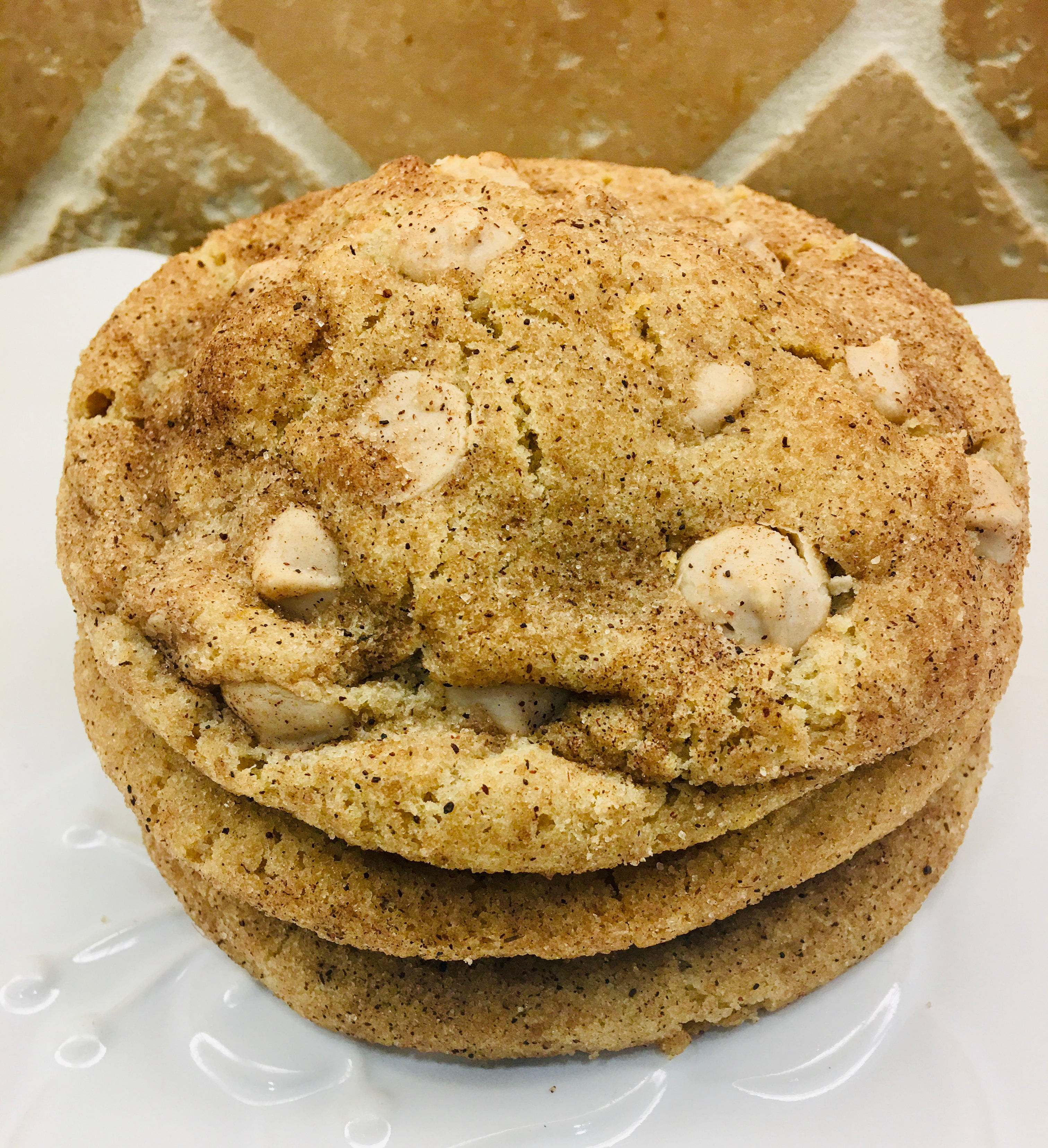 Stack of three cinnamon-dusted white chocolate cookies