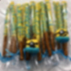 Minion-themed pretzel rods and treats on a platter