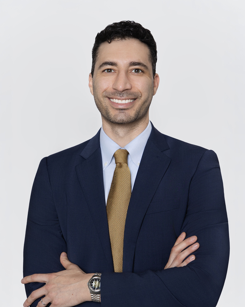 Professional headshot of a man in a suit with arms crossed, smiling, by Tina Dwyer Photography El Paso