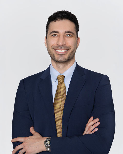 Professional headshot of a man in a suit with arms crossed, smiling, by Tina Dwyer Photography El Paso