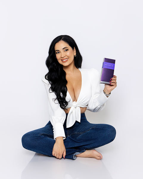 Professional branding portrait of a woman in a white top and jeans holding a smartphone, photographed by Tina Dwyer Photography in El Paso