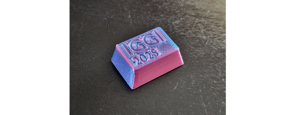 Purple keyboard key with an IGGI 2025 engraving