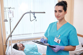 portrait-serious-young-nurse-surgical-gloves-making-notes-about-patients-health-while-fill