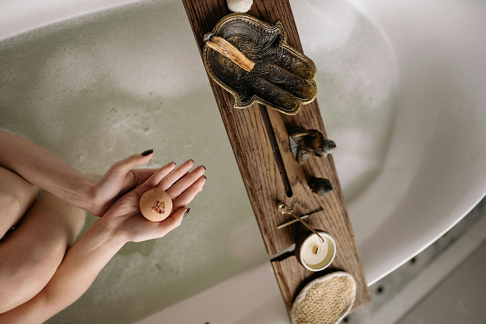 woman, grounding through a bathing ritual with palo santo and candles