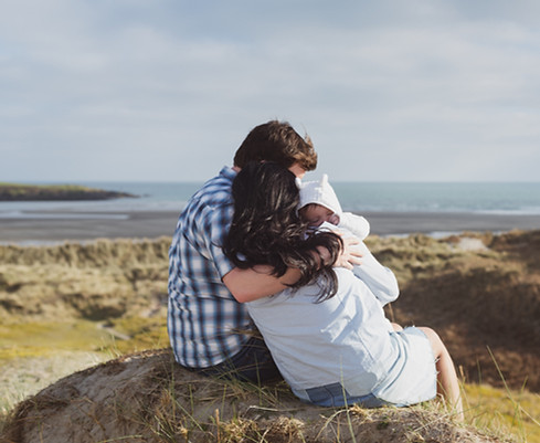 man-and-woman-sitting-on-stone-carrying-