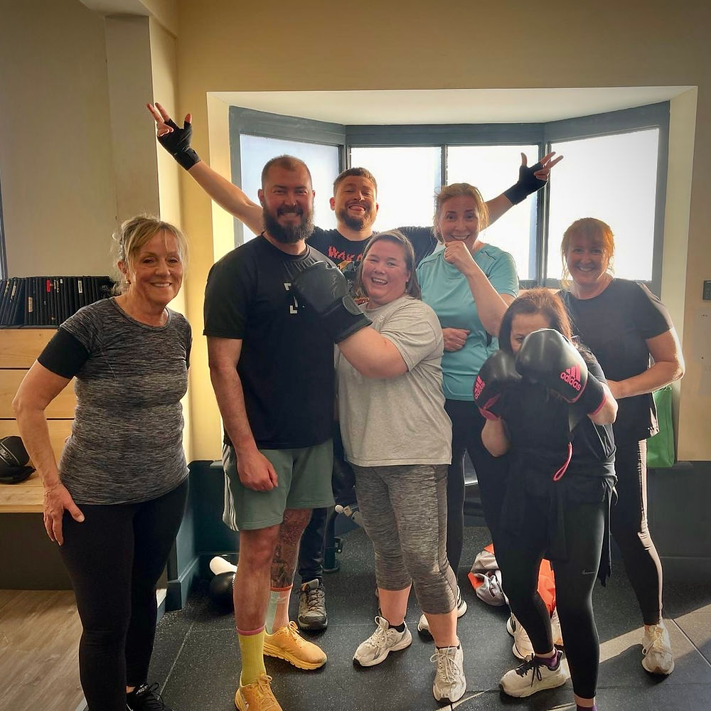 A group of members in a boxing workout