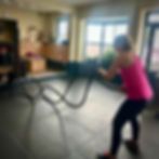 A woman using the battle ropes