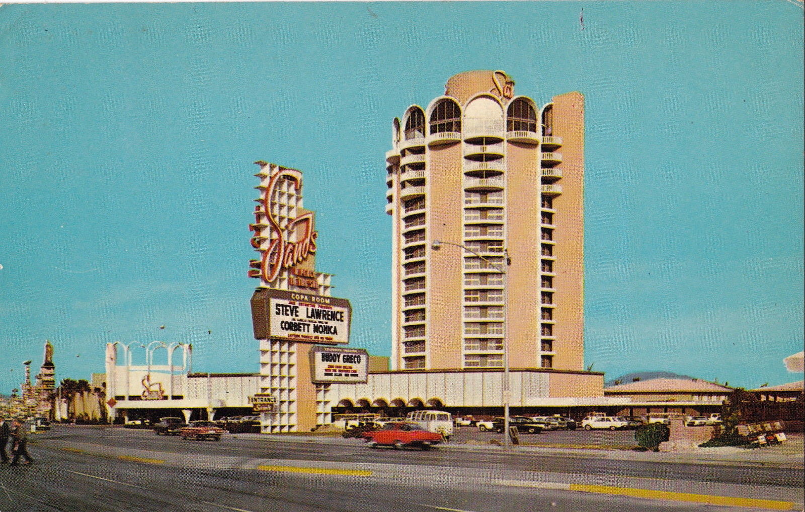 Wide archival photograph of the Sands Hotel and Casino showing the hotel tower, iconic Sands sign and entrance, circa 1967