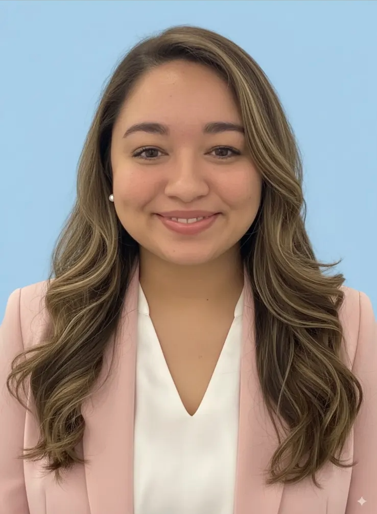 Smiling woman in a pink blazer and white shirt, looking at camera.