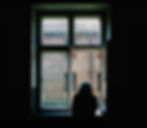 A person looking out the window