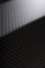 Closeup of carbon fiber weave on a dope subwoofer that is awesome.