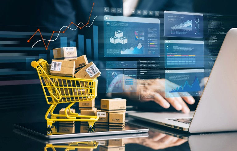 Image of small shopping cart filled with boxes on a workers desk