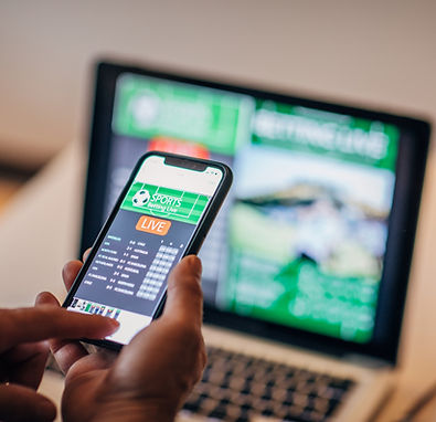 Hands of a African-American model showing examples of mobile-first responsive website desi