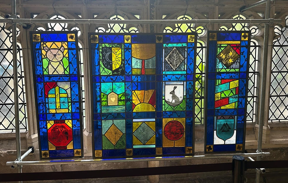 Painted stained glass from community workshops assembled into a leaded panel triptych.