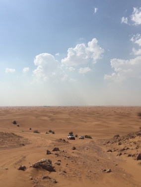 4WD cars climbing dune in Dubai desert