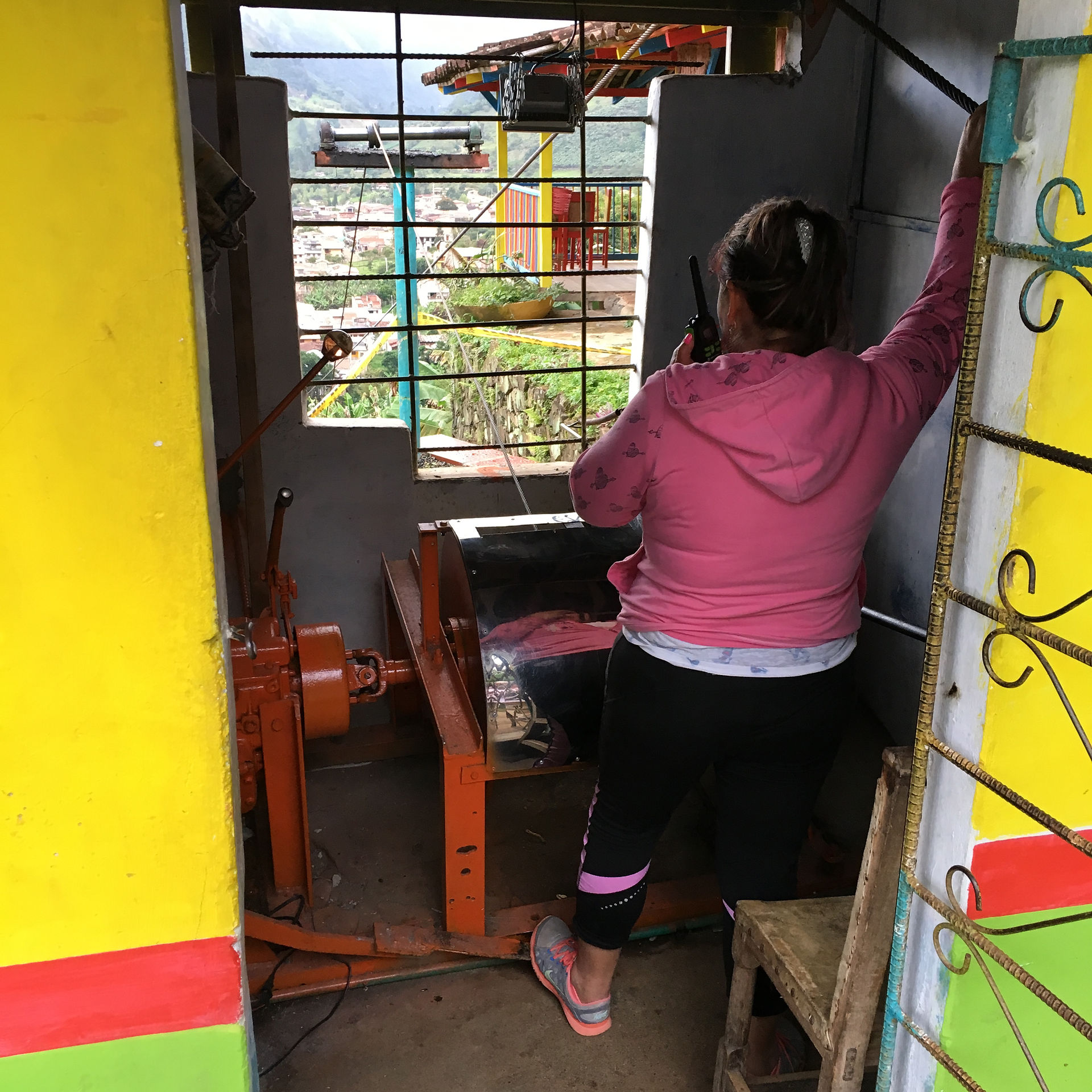 Woman operating wooden cable car in Jardin Colombia