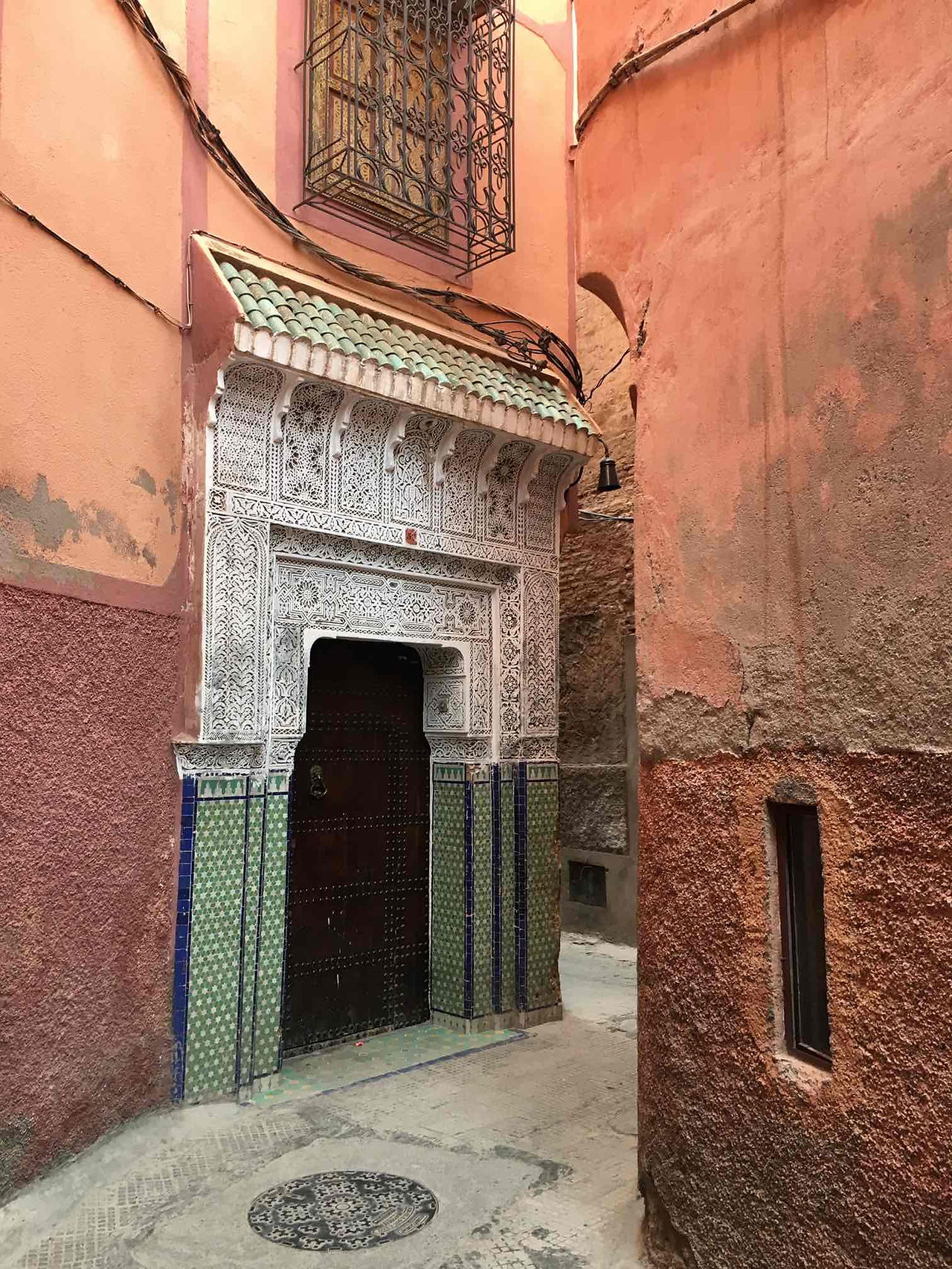 Orange alleyway with door in Marrakech Medina