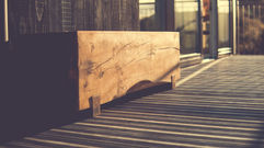 Solid oak outdoor bench on decking