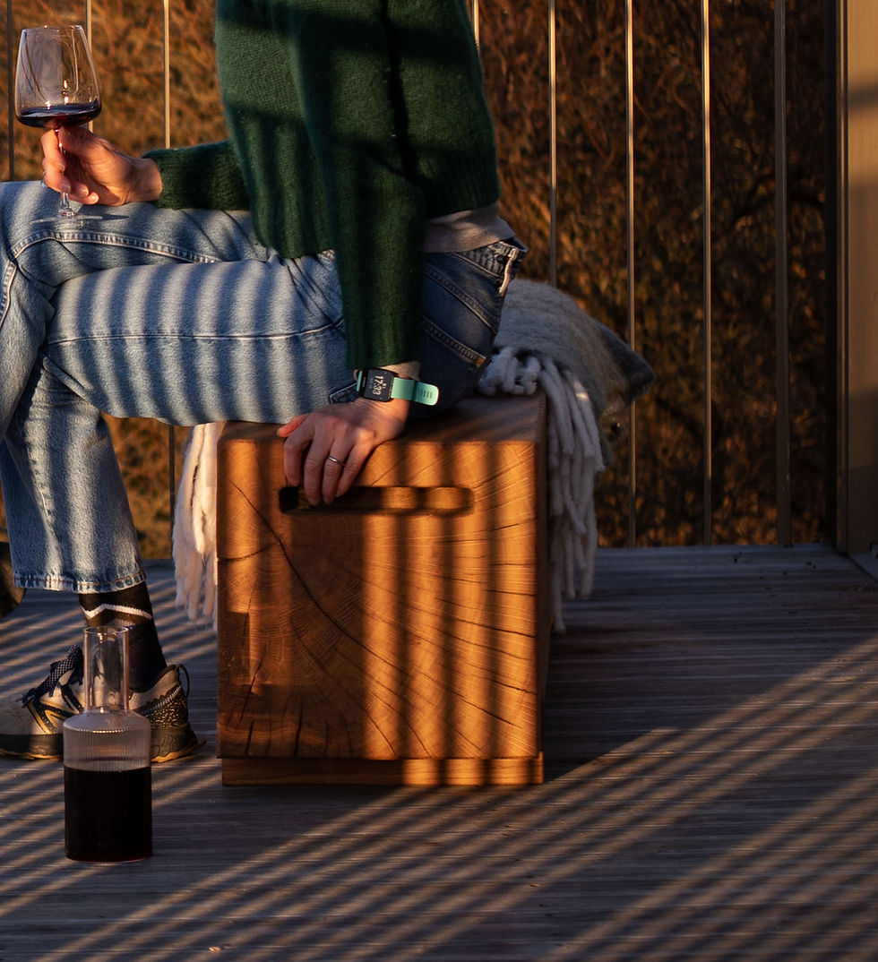 Thumbnail: Oak outdoor bench close up with woman sitting on it in jeans and wool jumper