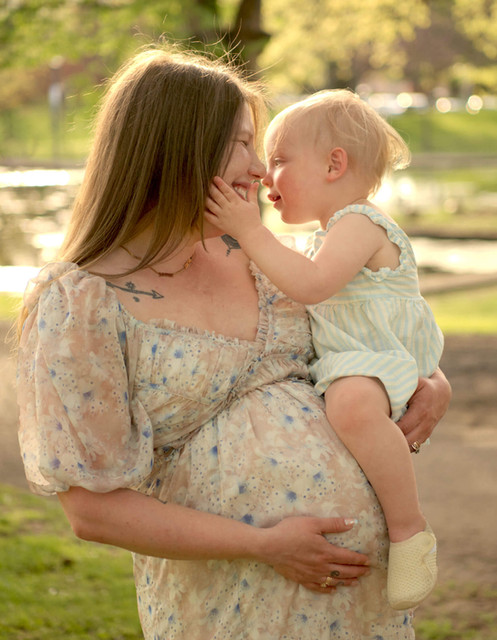 A pregnant mother holds her toddler daughter in front of Lake Elizabeth in Pittsburgh, PA.
