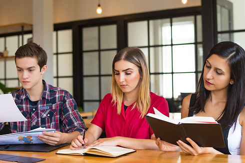 portrait-three-serious-students-studying-library.jpg