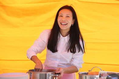 Participant Assisting with Rice Offering