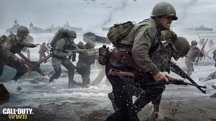 Soldados aliados desembarcando en la playa de Omaha bajo el fuego enemigo en Call of Duty: WWII.