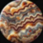 Close-up of a polished Prairie Agate stone showcasing earthy tones of brown, yellow, and red, with unique patterns and translucent sections highlighted by natural light.