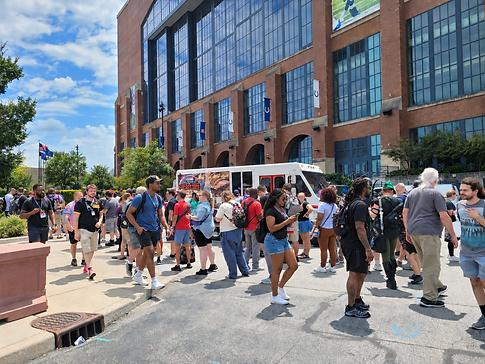 Crowd outside stadium by foodtruck.png