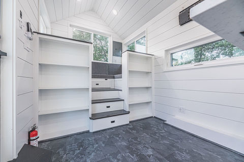 Caving tiny home living area by Movable Roots.